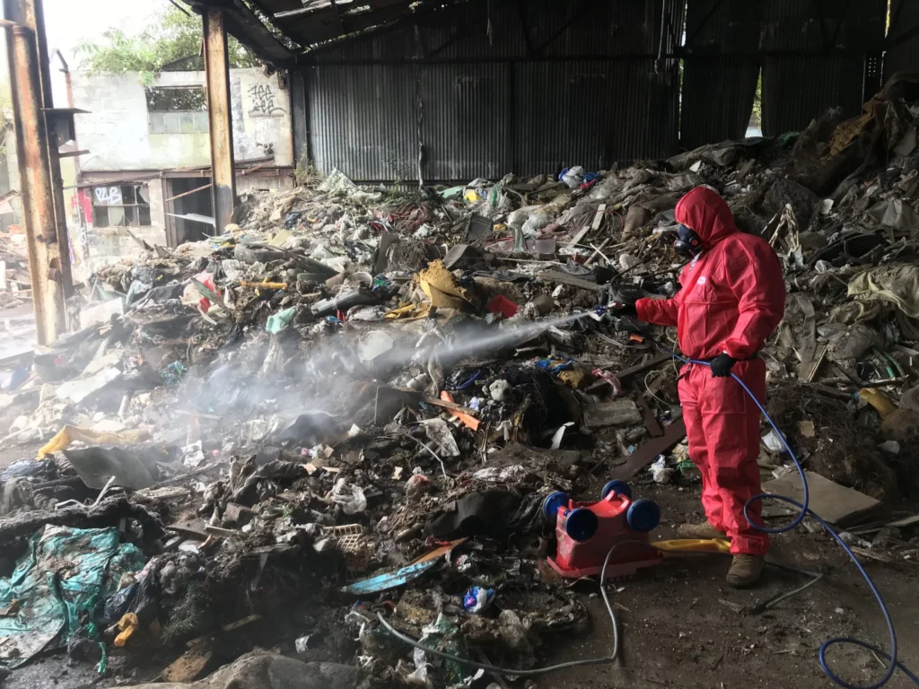 A man in a red overall is site cleaning